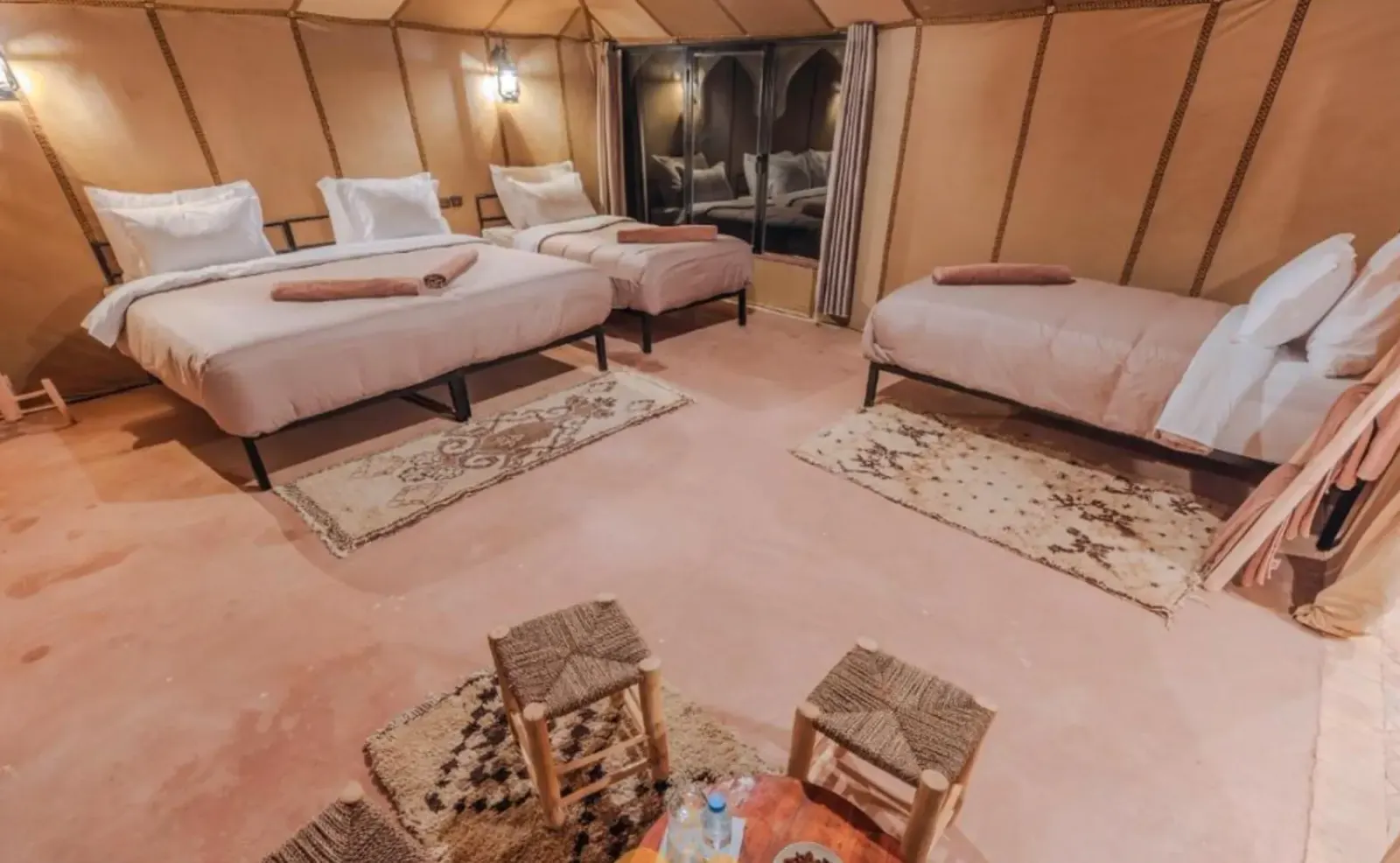 Tent room with beds and Berber rugs