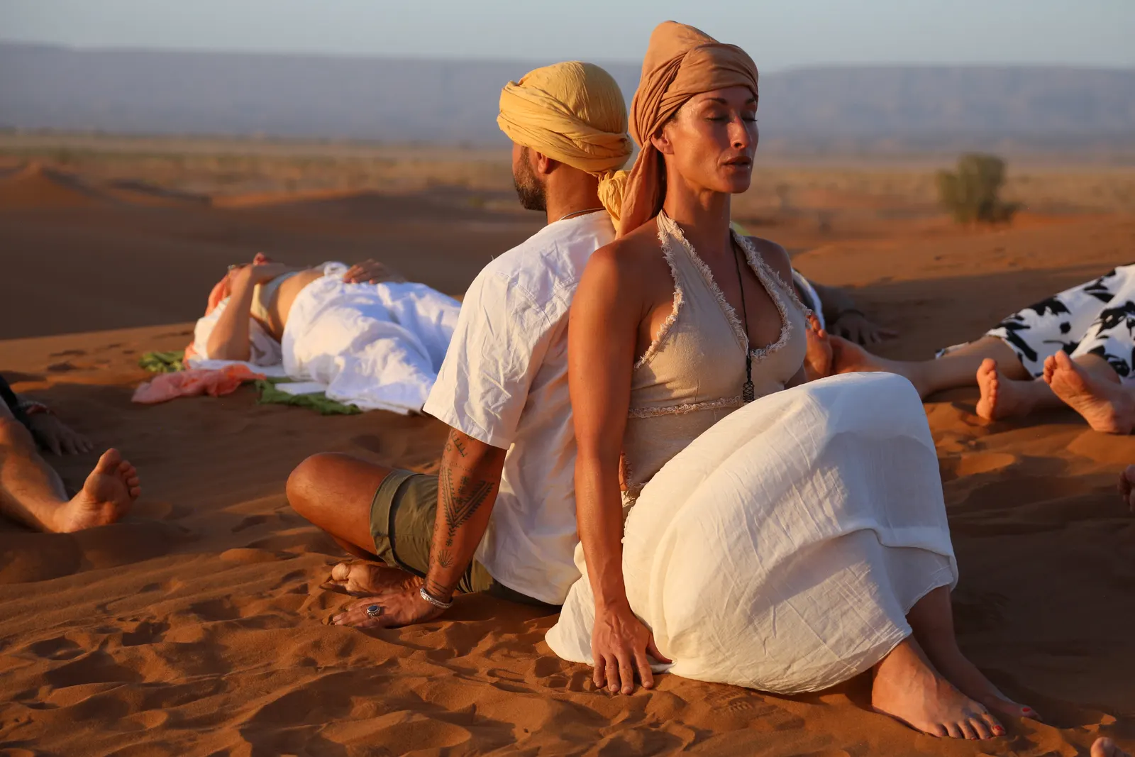 Melissa and Emmanuel guiding a retreat session on the dunes