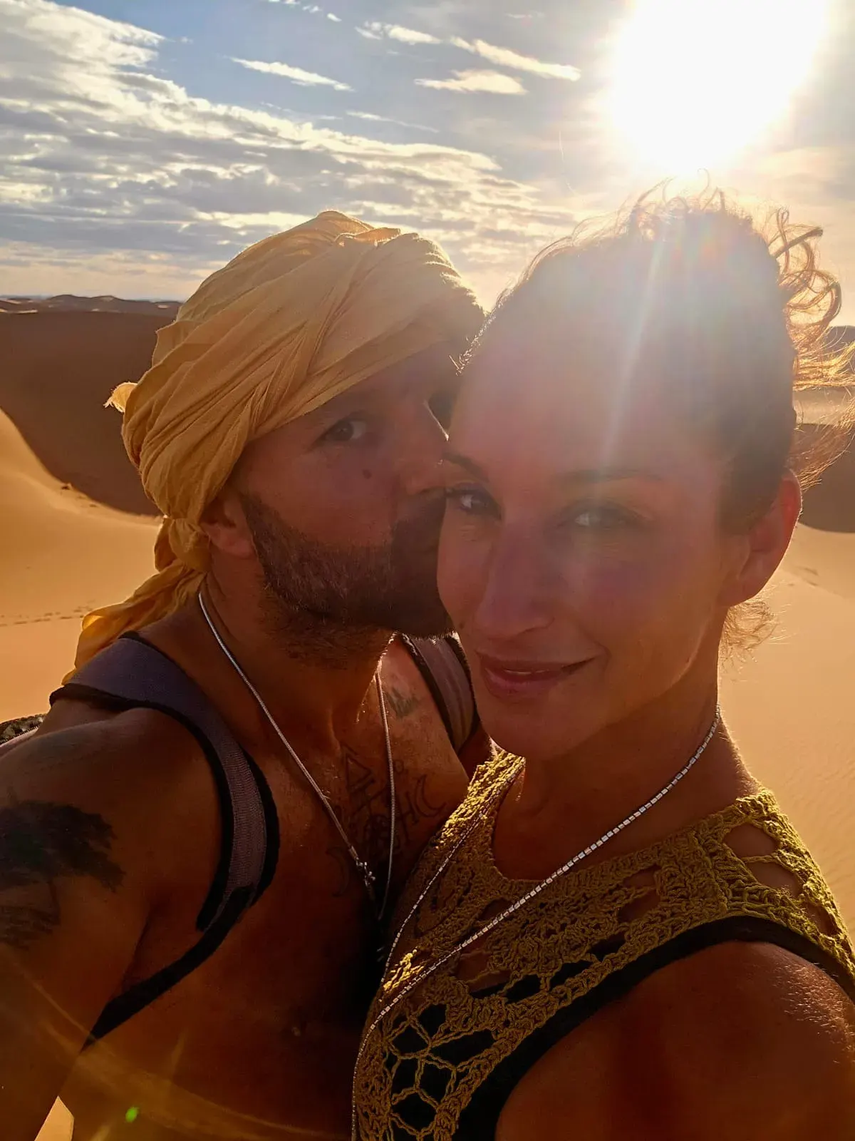Melissa and Emmanuel backlit on the desert dunes