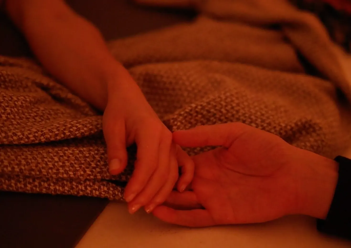 Two hands held together during a private EMME experience